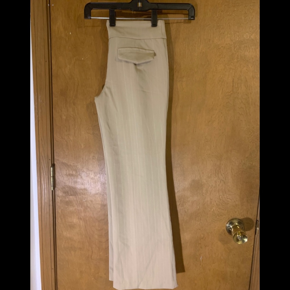 Beige high waisted flared pants.